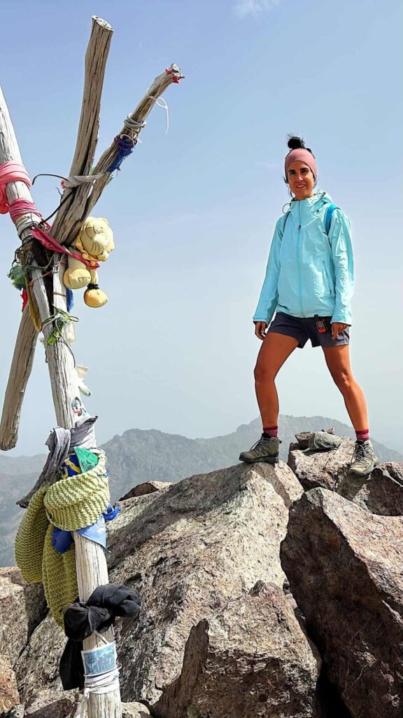 Hiker on top of Monte Cinto GR 20 trail in Corsica